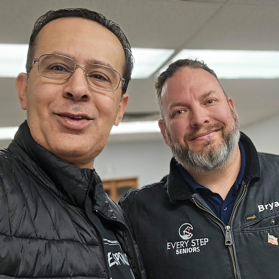 Two smiling men pose for a photo, highlighting connection and collaboration in senior living.