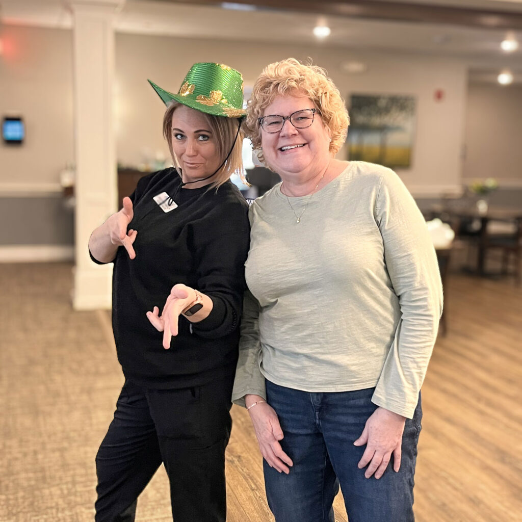 A team member and resident celebrate St. Patrick's Day at Vitalia North Olmsted.
