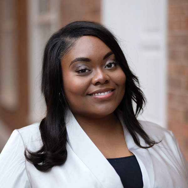 Shonae Houston, Memory Care Director at Vitalia North Olmsted, smiling in a professional headshot, wearing a light blazer, with a softly blurred indoor background.